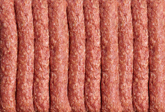 Raw pork and beef mince extruded into strips. Preparation for lula kebab.