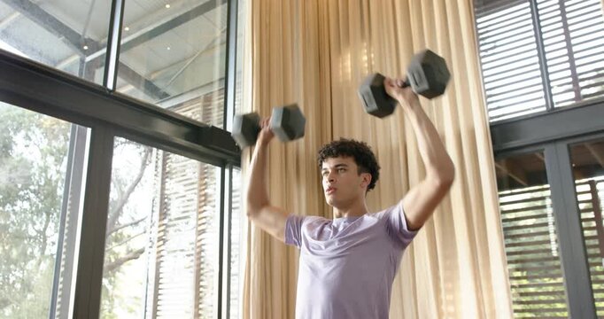 Lifestyle videos Indoor of people doing activities at home, Lifting dumbbells, man exercising indoor