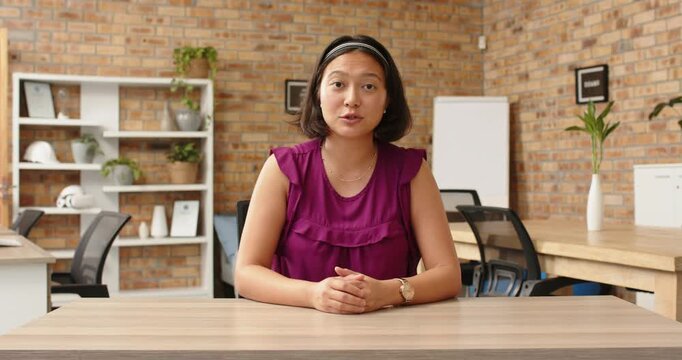 Close up of people talking to the camera, businesswoman in office sitting at desk, speaking and gest