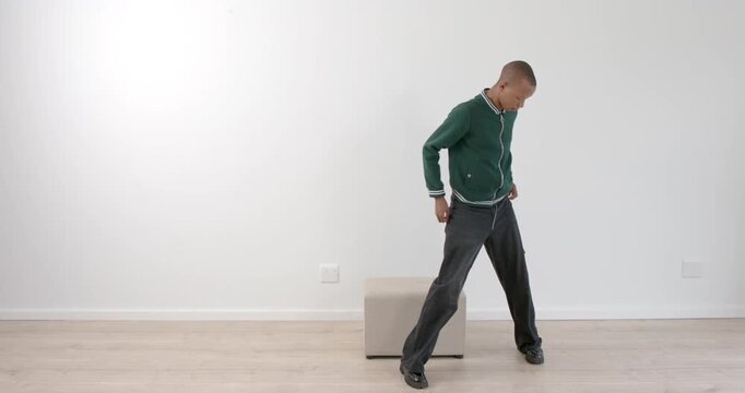 High-speed photography for dynamic scenes, standing casually, man in green jacket posing next to sma