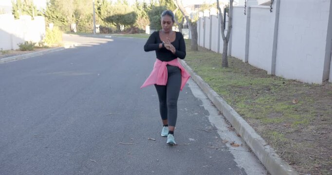 Lifestyle videos outdoor of people doing activities, Walking on suburban street, woman in athletic w
