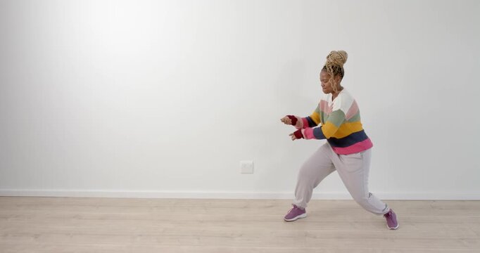High speed photography for dynamic scenes, Dancing in colorful sweater, woman enjoying herself in.