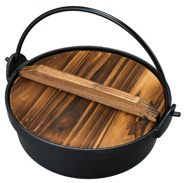 Black cast iron Japanese pot with bail handle and charred wooden lid on white background