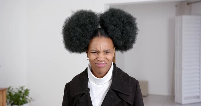 High speed photography for dynamic scenes, woman making funny face, wearing black coat indoors