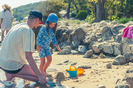 Father and Daughter Enjoying Quality Time Playing Together on the Beach