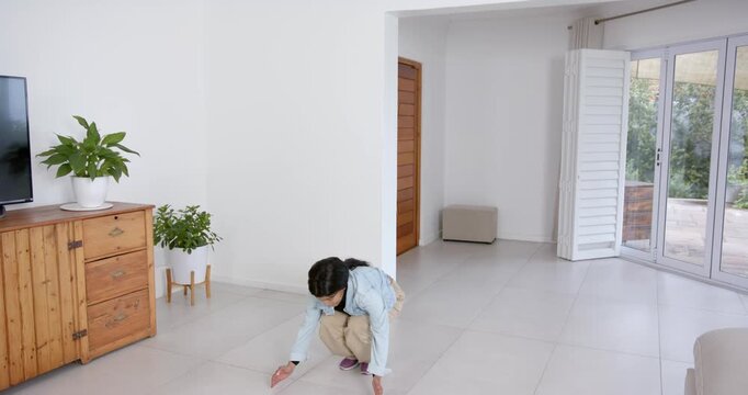 High speed photography for dynamic scenes, woman bending forward with arms outstretched in modern li