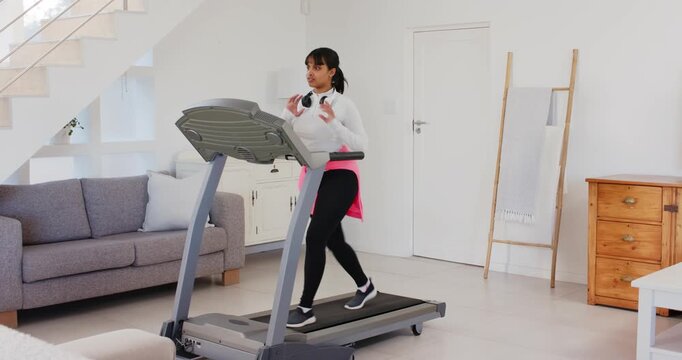 Lifestyle videos indoor of people doing activities at home, walking on treadmill, woman wearing head