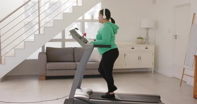 Lifestyle videos indoor of people doing activities at home, exercising on treadmill, woman listening