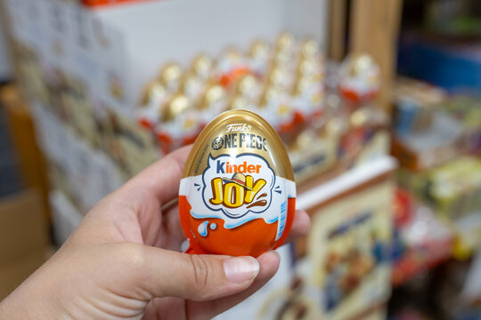 Hand holding Kinder Joy egg featuring Funko One Piece branded packaging inside store. Kaliningrad, Kaliningrad Region, Russia. September 15, 2026.