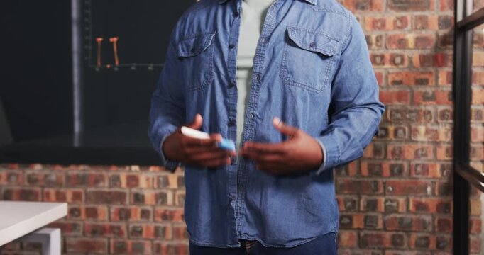 Close up of people talking to the camera, holding marker, man standing in front of chalkboard in cla