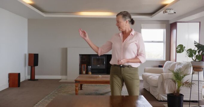 Close up of people talking to the camera, Walking in living room, woman in casual attire enjoying ho