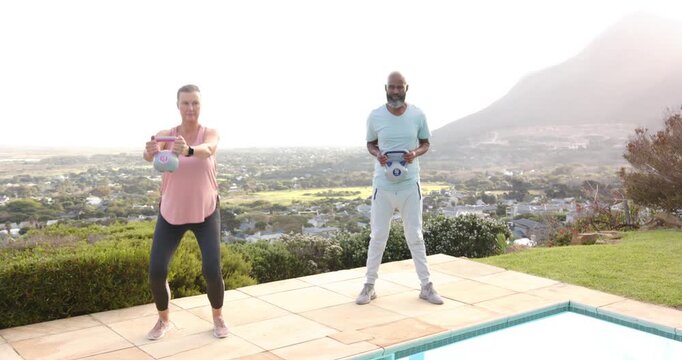 Lifestyle videos outdoor of people doing activities, exercising outdoors, couple lifting dumbbells b