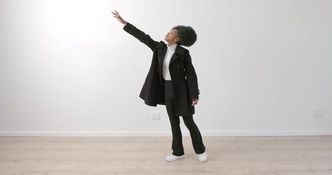 High speed photography for dynamic scenes, Reaching upwards, woman in black coat posing gracefully i