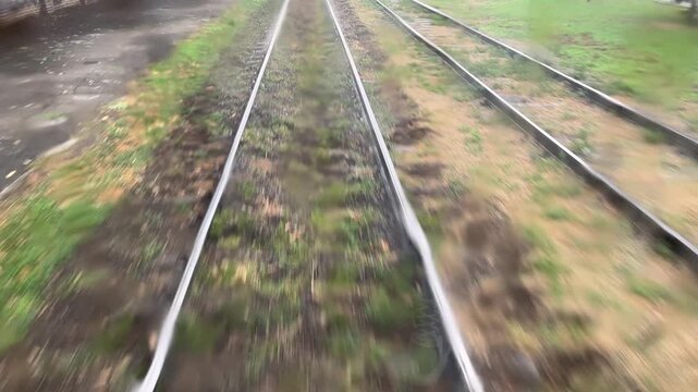 Passenger commuting on a tram on rainy day
