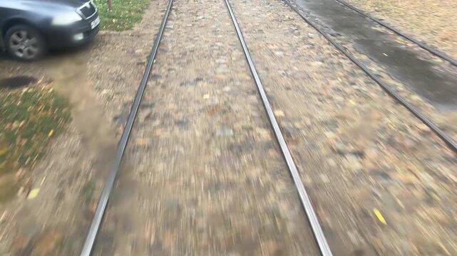 Tram path: passenger's POV on wet railroad