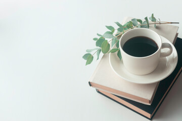 Coffee cup on books with eucalyptus and copy space on white background © 清美 小池