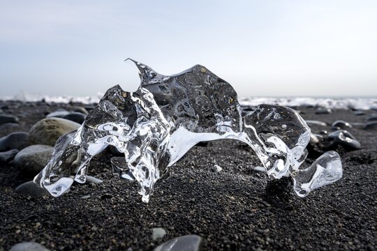 Ice, piece of ice on black sand beach, on black lava beach Diamond Beach, Southeast Iceland, Iceland