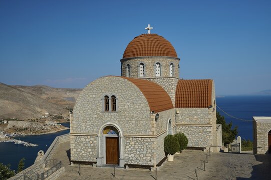 Agiou Sarvas monastery, Agion Pandon church, stone church with brown dome and sea view in mountainous landscape, Pothia, main town, port, Kalymnos, Sponge Diving Island, Dodecanese, Greek Islands, Greece
