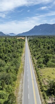 Carretera Austral, Long straight road, aerial view, city view with harbor and sea, Hornopir&eacute;n, Patagonia, Los Lagos, Chile