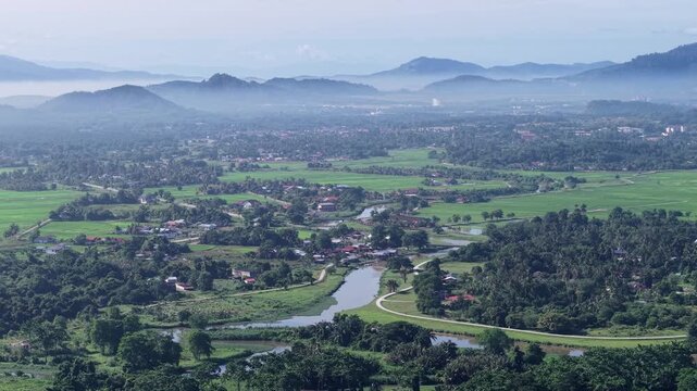 A picturesque landscape featuring lush greenery, a winding river, rolling hills, and expansive valley at Kubang Semang