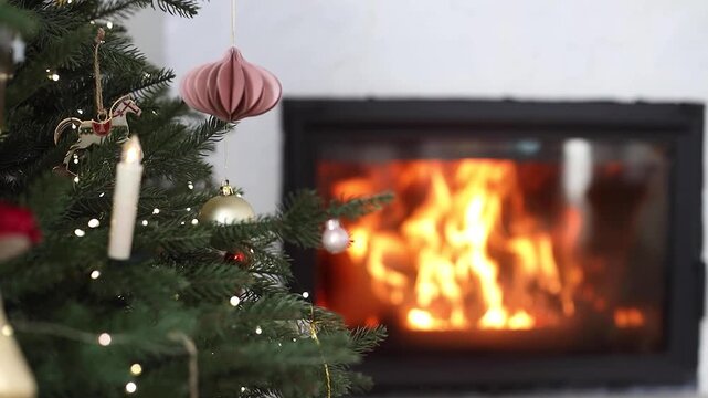 Glowing Christmas Tree on background of Cozy Fireplace in Modern White Living Room, calm video.  Winter Home Warmth. Christmas Eve, Domestic Relaxation