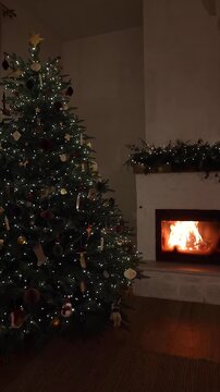  Illuminated Christmas Tree Beside Burning Fireplace video, Authentic Winter Holiday. Cozy Home Atmosphere, Christmas Holiday Relaxation