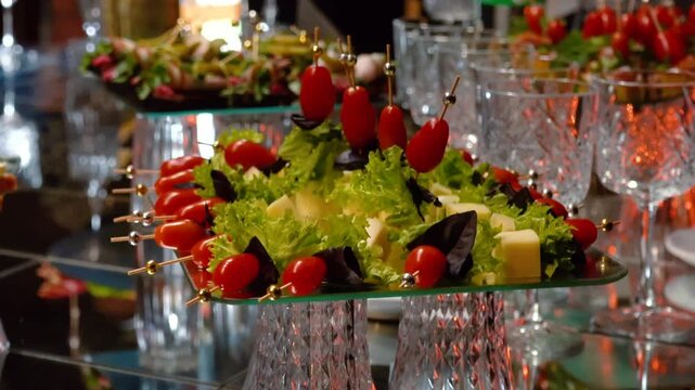 Fruits, cakes, and sweets on a festive banquet table before a business event or other celebration. Sweet drinks for guests.