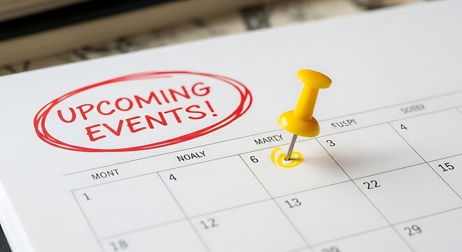 Yellow pushpin marking important upcoming events on a white calendar page