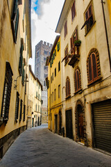 Fototapeta premium Lucca, Italy: old street with the belfry of the San Frediano church