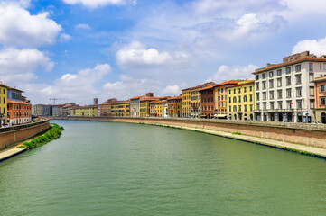 Obraz premium The Arno river at Pisa, Italy, with historic buildings