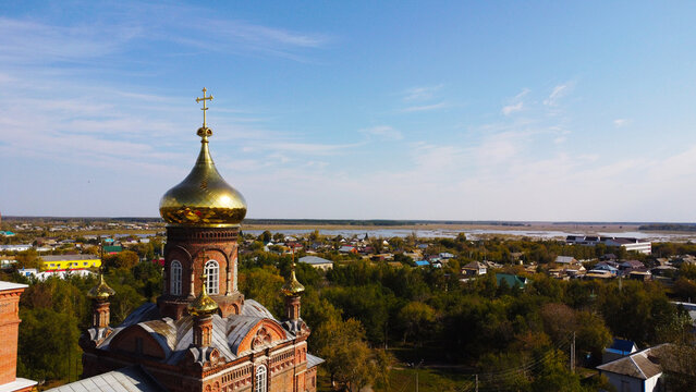 Aerial View of Golden Dome and Cross of Red Brick Orthodox Church