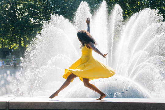 South Asian woman dancing barefoot