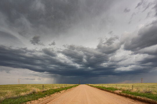 Developing Supercell storm over dirt road in wyoming grasslands