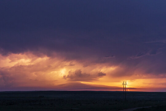 Shelf Cloud and lightning strike at sunset over montana plains