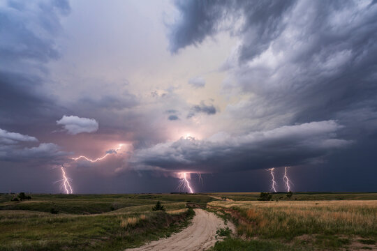 Lightning strikes from Supercell storm over rural nebraska grasslands