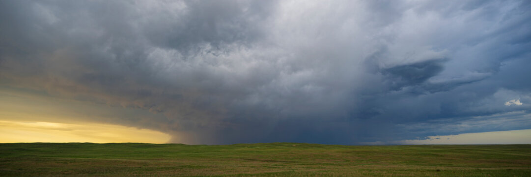Receding Storm clouds over prairie landscape