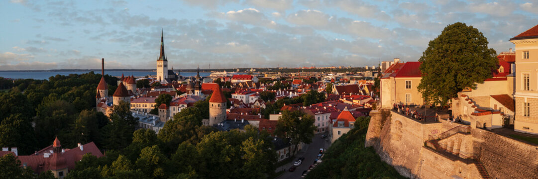 Tallinn skyline at sunset with historic fortress and church steeple