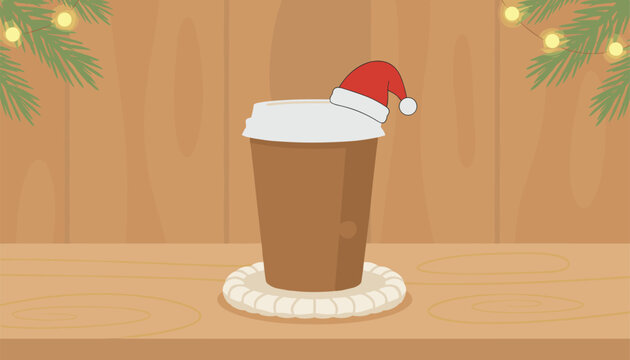 Takeaway brown paper coffee cup with a santa hat sits on a coaster surrounded by festive pine branches and warm fairy lights.