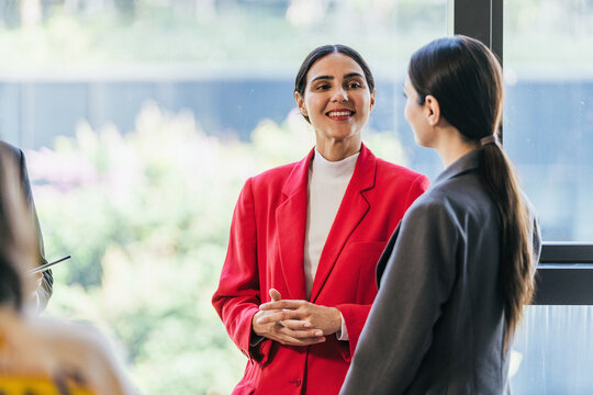 Businesswomen Networking and Discussing Ideas in Modern Office