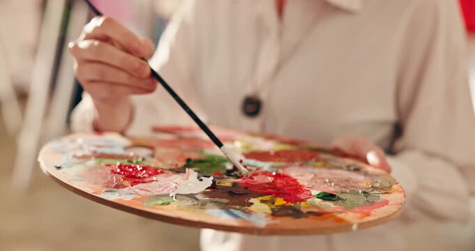 Hands, brush and blend paint with palette to create different color, DIY project and design process. Painter, tray and woman mix pigment in art studio with tools, creative skills or prepare for hobby