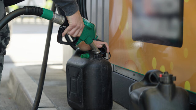Filling-up the fuel container at gas station close-up