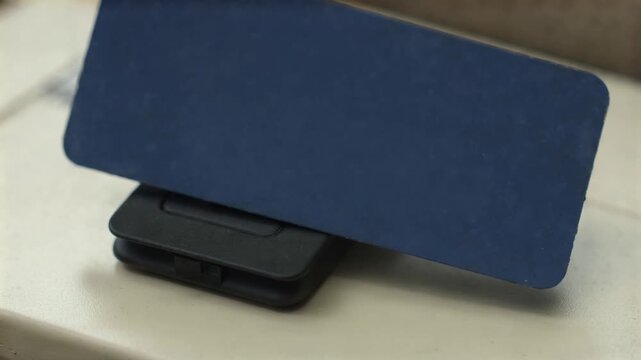 Plain bank card touching a contactless reader