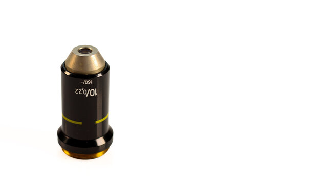 10x optical microscope objective with 0.22 numerical aperture, 160 mm tube length and yellow identification ring, isolated on white.