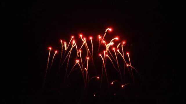 Explosion of Red Sparks in the Night Sky, a Dazzling Firework Display Sparkle