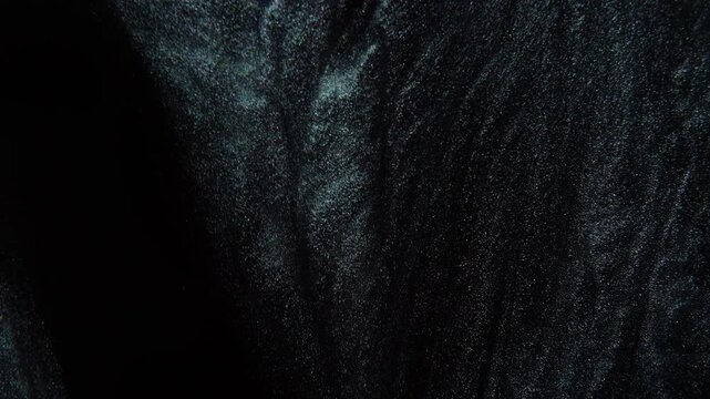 The movement of small, shiny particles resembling star dust.