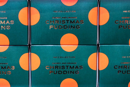 Close-Up Of Marks And Spencer Collection Cherry And Orange Christmas Puddings In Festive Packaging, UK