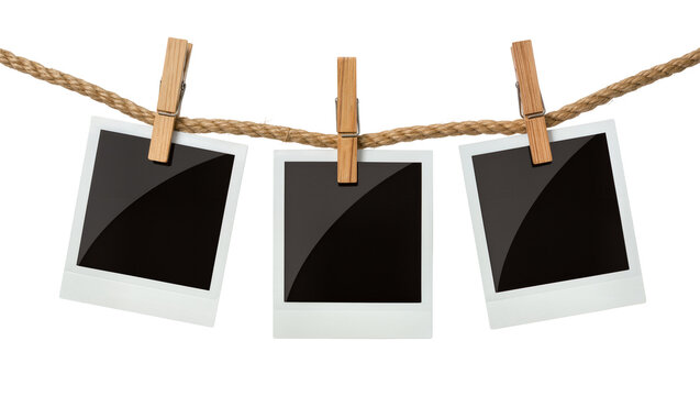 Three blank instant photo prints clipped to a rope, isolated on transparent background