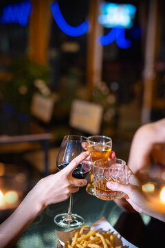 food and drink male friends are happy drinking beer and clinking glasses at a bar or pub.