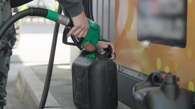 Filling-up the fuel container at gas station close-up