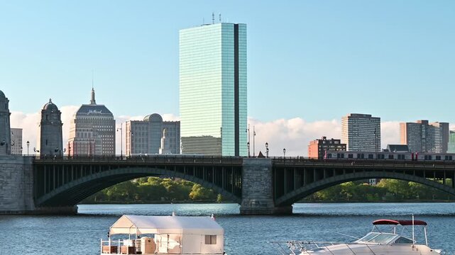 The skyline of Boston in Massachusetts showcasing the iconic Longfellow bridge with the T train moving on it on a sunny morning.